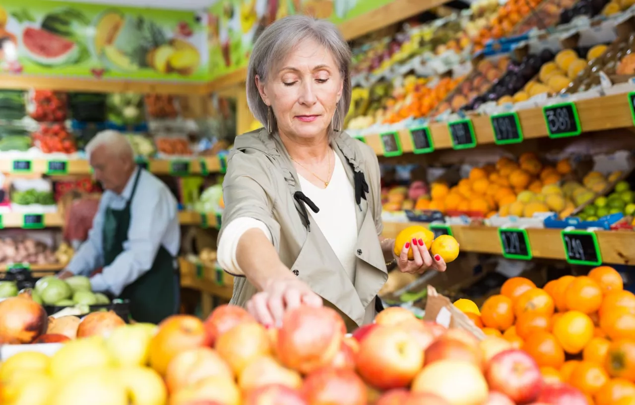 &lt;p&gt;Klientka w sklepie wybiera owoce (fot. Shutterstock)&lt;/p&gt;