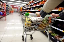 London, UK - August 18, 2014A shopper pushes a trolley along an aisle in an Asda supermarket. American company Walmart owns Asda, which is UK‘s largest retail chain after Tesco with 568 stores.