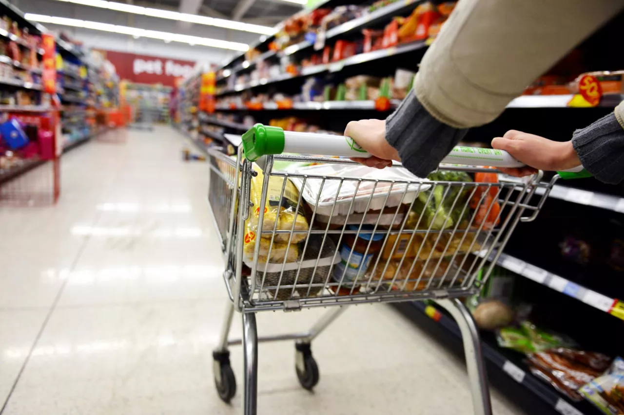 London, UK - August 18, 2014A shopper pushes a trolley along an aisle in an Asda supermarket. American company Walmart owns Asda, which is UK‘s largest retail chain after Tesco with 568 stores.