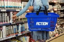 KAMPEN, THE NETHERLANDS - JULY 12, 2016Shopping woman with shopping basket in a Action discount superstore. Action is a Dutch discount store-chain. Sells in their stores low budget products.